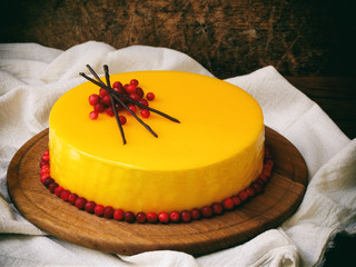 cake covered with a mirror coating, decorated with cranberries and chocolate decor. Modern Russian honey cake. Photo Rustic. Selective focus