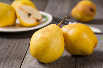 Fresh ripe organic yello pears on rustic wooden table, natural background, diet food.