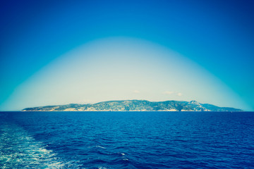 Deep blue filtered vignetted panorama view of Argentario peninsula on the Tyrrhenian Sea - Nature...