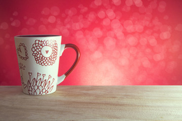 red pattern coffee cup and bokeh background