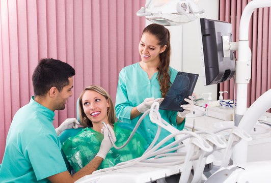 Dentist and client looking an x-ray image