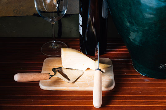 Still life with cheese and a bottle of red wine