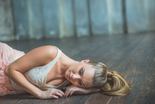Beautiful ballet dancer lying on floor