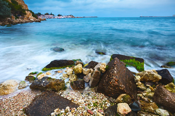 Landscape of the sea shore with a long exposure. The stones of g