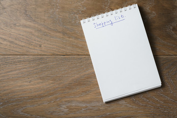 shopping list on notepad on wood table