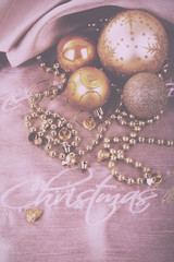 Festive gold Christmas decorations on fabric background Vintage