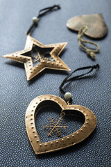 Bronze Christmas star and  hearts on a dark blue background.