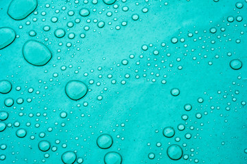 Drops of water on a dusty green color background. Shallow depth of field. Selective focus. Toned.