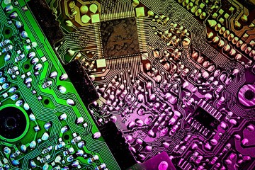 Abstract technology background computer motherboard, toned in violet yellow green colors