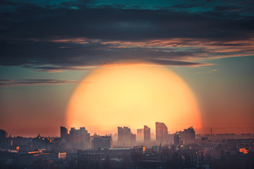 Aerial view of city sunset with big orange sun in Kiev, Ukraine
