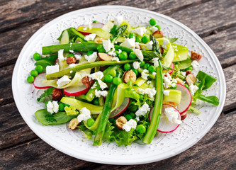 Fresh Green Asparagus salad witch Goat Cheese, peas, radishe, zucchini, lettuce and Hazelnuts.