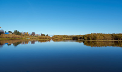 Fall River, reflected in the water autumn trees.