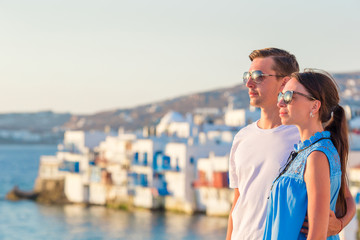 Fototapeta na wymiar Family in Europe. Young couple on Little Venice background on Mykonos Island, in Greece