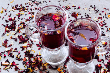 Fruit tea in a two glass cups on a grey stone background