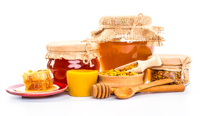 Still life with honey, honeycomb, pollen and propolis on a white