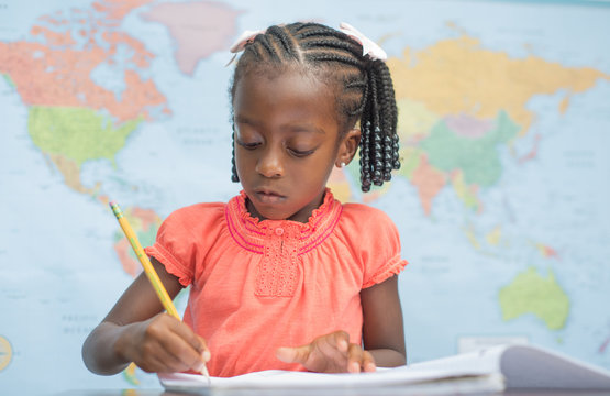 Education/Cute Little African American Preschool Girl Writing In A Classroom