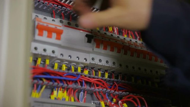 Trip Switch Fuse box. Man hands turning on all switches in a electricity, power shield, fuse box. HD.