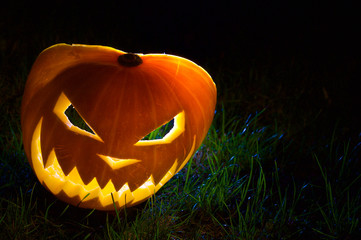 Halloween Pumpkin in grass at night