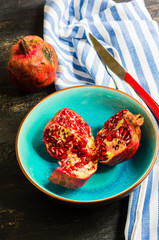 Ripe pomegranate on wooden table