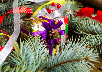 Christmas presents with red ribbon on dark wooden background in