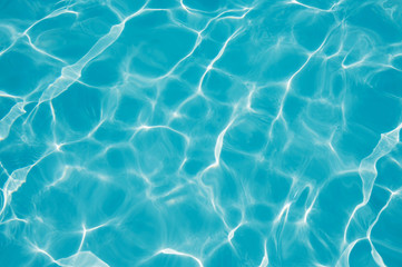 Blue water surface with sun reflection