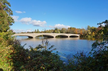 Fototapeta na wymiar Fall foliage over the Washington Bridge on Lake Carnegie in Princeton, New Jersey