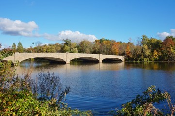 Fototapeta na wymiar Fall foliage over the Washington Bridge on Lake Carnegie in Princeton, New Jersey