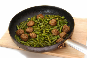 Swedish meatballs with green beans in a skillet