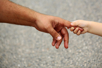 babys hand holding mothers