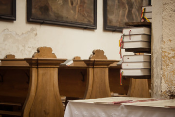 Fototapeta na wymiar Close up of book stack in old church