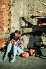 Zombie man with halloween pumpkins