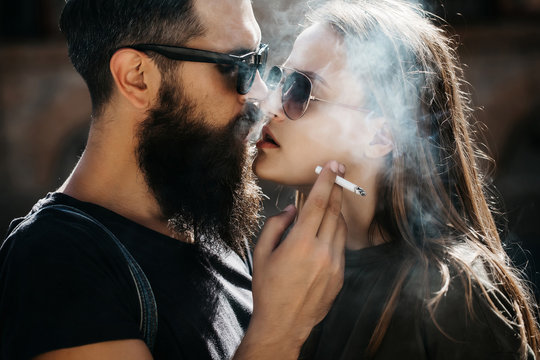 happy loving couple smoking
