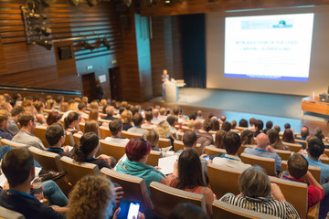 Speaker giving a talk on scientific conference. Audience at the conference hall. Business and...