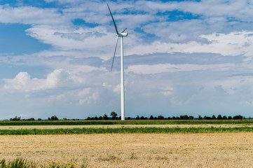 Windmill for electric power production in country side background, Poland