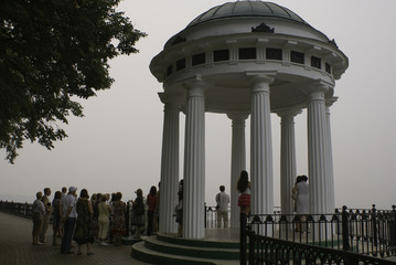 Tour group in the morning in the fog in white gazebo