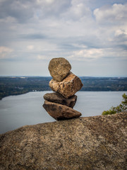 Cairn on a cliff over river