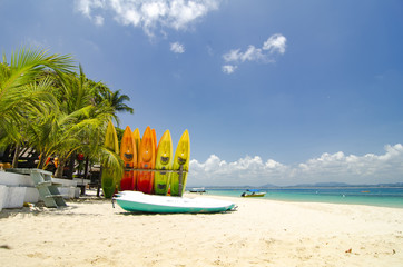 surface level shot,beautiful beach scenery, kayaks stack on whit