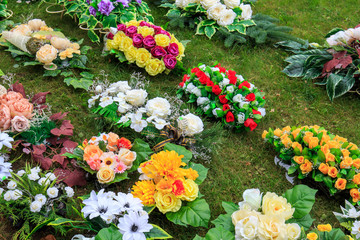 Plastic flowers in baskets on the grass