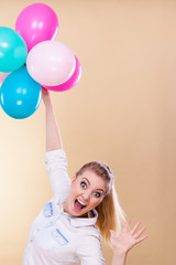 Obraz na płótnie Canvas joyful girl playing with colorful balloons