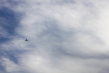 Airplane in the cloudy sky