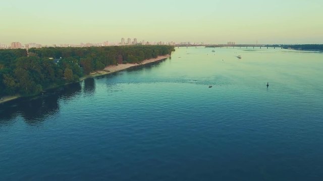 Aerial Drone Flight Footage: Dnipro river and cityscape at sunset. Magestic landscape. Kiev, Ukraine, Europe. 4K resolution.