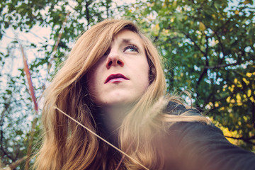 Looking up woman portrait in the nature