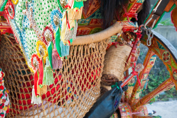 Close-up view of a colorful harness of a typical sicilian cart during a folk festival