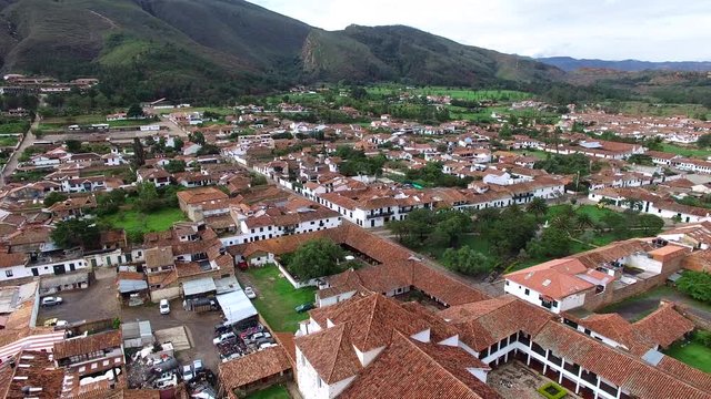 Aerial view of camera flying away from the church on the main plaza in Villa de Leyva, Colombia