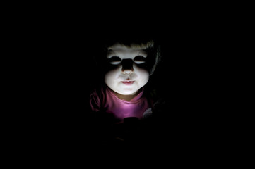 child telling scary story  in the dark