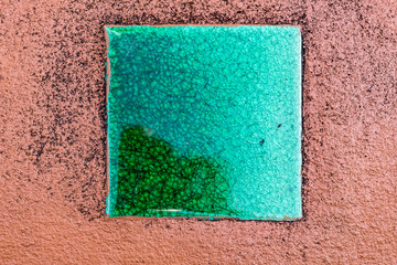 Fototapeta premium Green ceramic tile on concrete