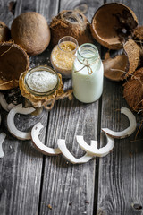Fresh coconuts broken on wooden background