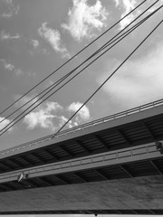 Low angle monochrome view of Danube Bridge against sky and clouds in Bratislava