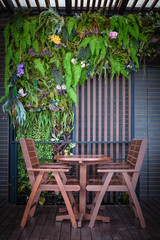 Fototapeta premium wooden table and chairs in the cafe. wooden chair and table at front porch. something on table in garden.