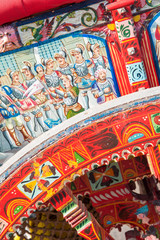 Close-up view of a colorful wheel of a typical sicilian cart during a folkloristic show